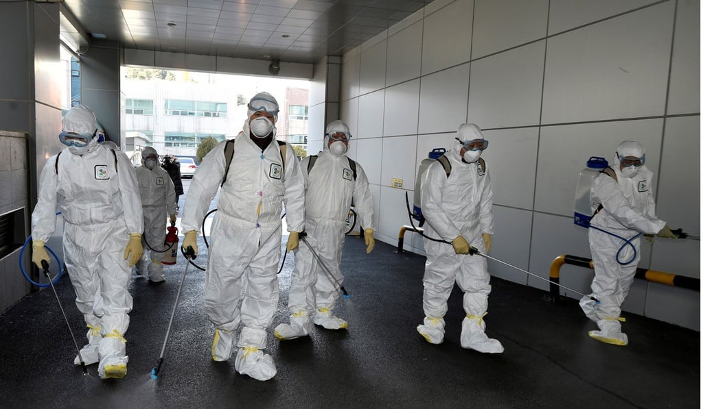 Workers sanitise a branch of the Shincheonji Church of Jesus in Daegu, South Korea. Photo: Reuters