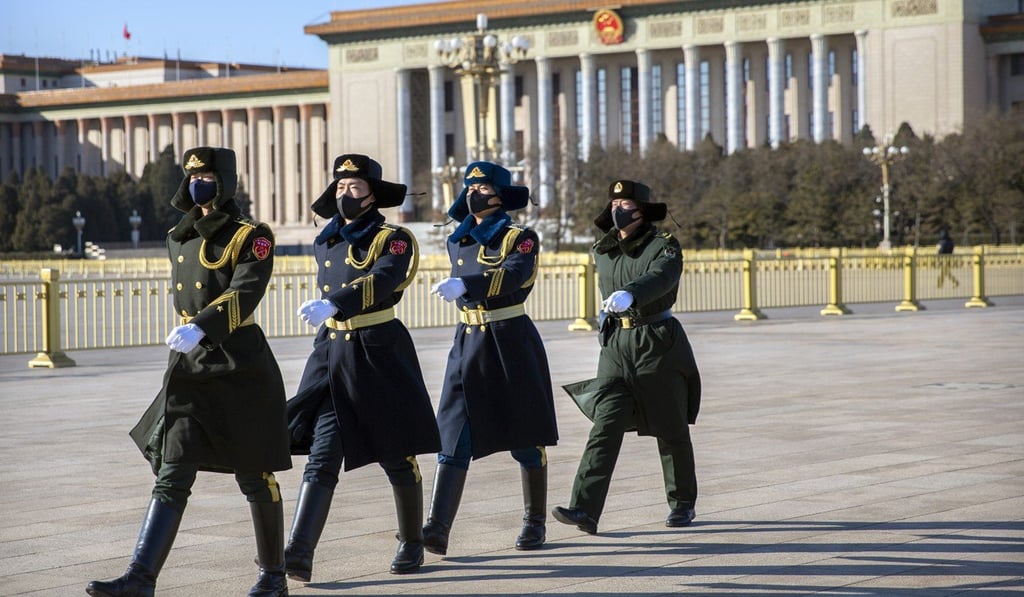 Members of a Chinese honour guard wear face masks as they march in formation near the Great Hall of the People on Tiananmen Square in Beijing. Photo: AP