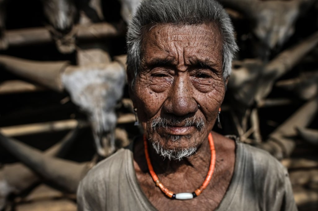 A Naga tribesman standing in front of his house in Myanmar. Photo: AFP