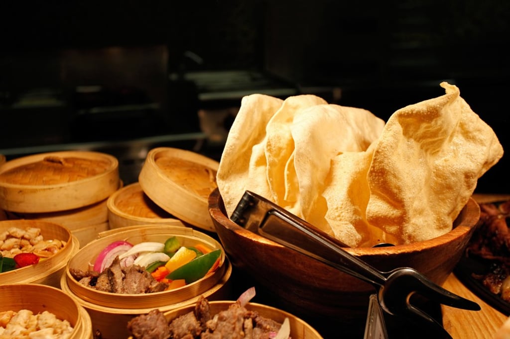 Steamer baskets with a variety of Chinese food – paired with large prawn crackers. Photo: Getty Images/iStockphoto Steamer baskets with a variety of Chinese food – paired with large prawn crackers. Photo: Getty Images/iStockphoto