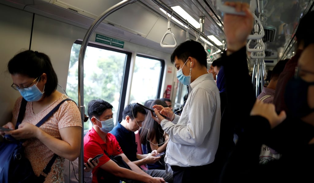 Commuters seen wearing masks on a train in Singapore on February 18, 2020. Photo: Reuters Commuters seen wearing masks on a train in Singapore on February 18, 2020. Photo: Reuters