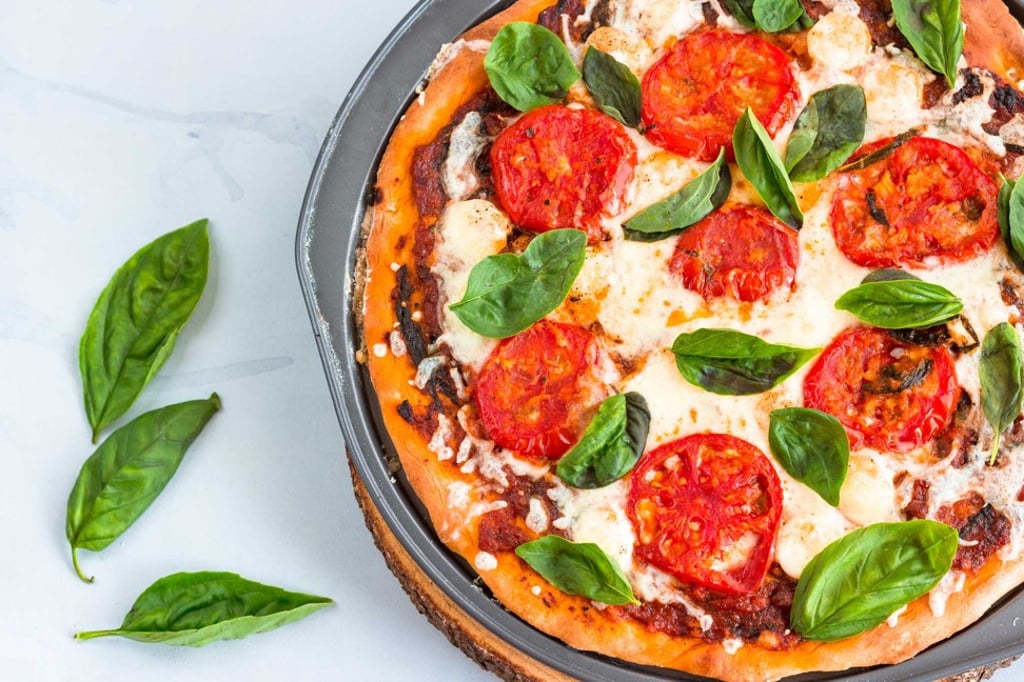 Margherita Pizza is a thin-crust pizza topped with tomatoes, fresh mozzarella and fresh basil leaves – said to represent the Italian flag. Photo: Getty Images/iStock