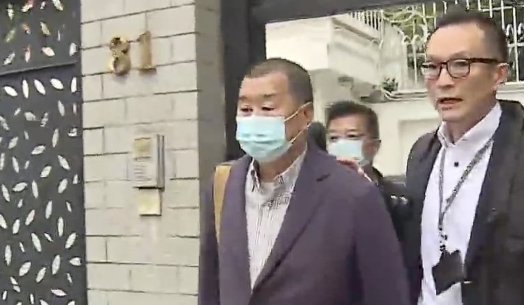Jimmy Lai being escorted out of his house in Ho Man Tin. Photo: TVB
