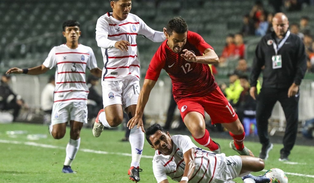 Forward Giovane da Silva of Hong Kong (in red) avoids a challenge from a Cambodia player during their 2022 World Cup qualifier at Hong Kong Stadium. Photo: May Tse