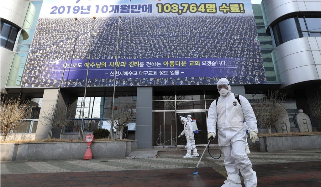Workers disinfect the front of the Shincheonji Church in Daegu, South Korea, to guard against the coronavirus. Photo: AP