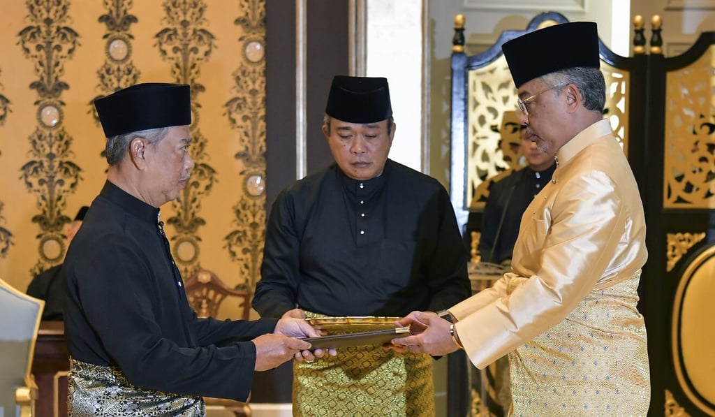 Malaysia's incoming Prime Minister Muhyiddin Yassin (left) receiving documents from Malaysia King Sultan Abdullah Sultan Ahmad Shah (right) before taking the oath as the country's new leader at the National Palace in Kuala Lumpur, Malaysia. Photo: Handout Malaysia's incoming Prime Minister Muhyiddin Yassin (left) receiving documents from Malaysia King Sultan Abdullah Sultan Ahmad Shah (right) before taking the oath as the country's new leader at the National Palace in Kuala Lumpur, Malaysia. Photo: Handout