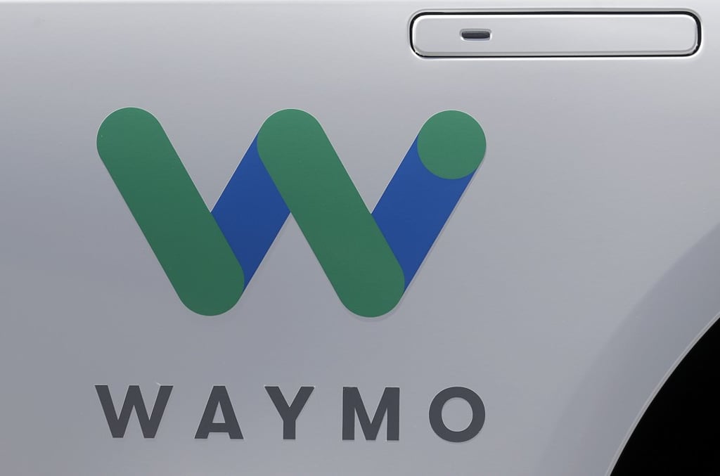 A Waymo logo is displayed on the door of a car at the Google I/O conference in Mountain View, California. Photo: AP