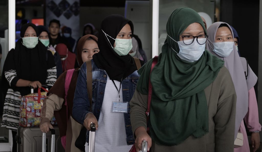 Women wearing face masks are pictured in Cengkareng, Indonesia. Photo: TNS