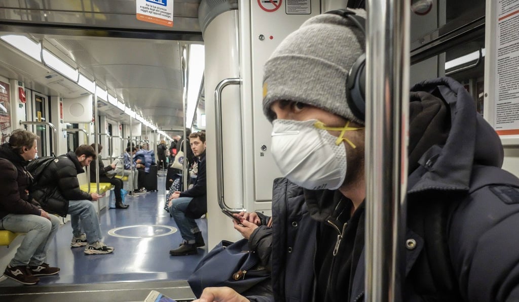 A man wearing a protective mask travels on Milan's metro. Photo: EPA