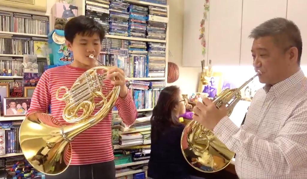 A still from a video of Homer Lee, French horn player with the Hong Kong Philharmonic Orchestra, making music at home with his wife, percussionist Sophia Woo, and their son Yannis. The video is one of a number posted by the orchestra while it is unable to give concerts. Photo: Hong Kong Philharmonic Orchestra