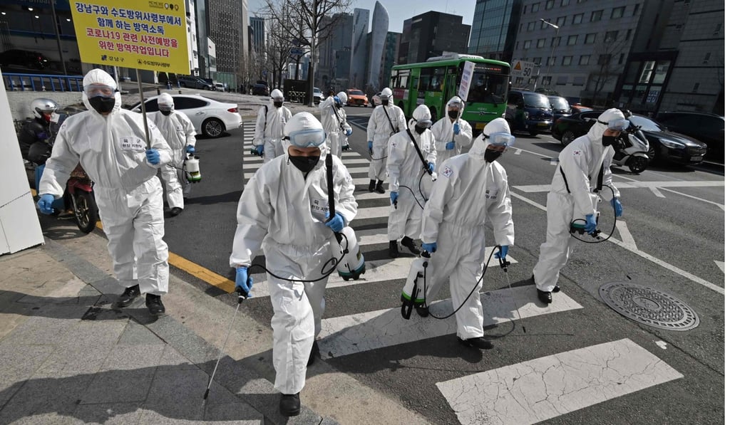 South Korean soldiers wearing protective gear spray disinfectant on the street to help prevent the spread of the Covid-19 coronavirus, in Seoul. Photo: AFP South Korean soldiers wearing protective gear spray disinfectant on the street to help prevent the spread of the Covid-19 coronavirus, in Seoul. Photo: AFP