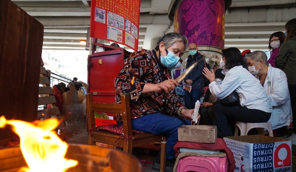 A beater pounds a paper effigy with a shoe under the Canal Road flyover during the White Tiger Festival. According to folklore, it is the best day of the year for people to 'beat away' their enemies. Photo: Sam Tsang