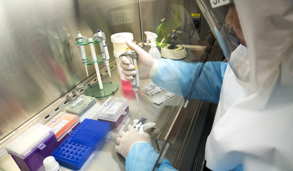 A laboratory technician from Singapore’s Home Team Science and Technology Agency pictured with part of the new test kits on Thursday. Photo: Bloomberg