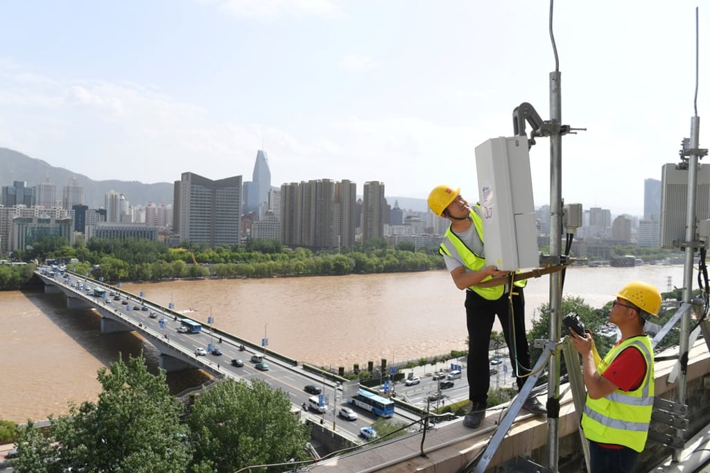 China Telecom technicians set up a 5G base station near the Yellow River in Lanzhou, Gansu province, in May of last year. Market estimates indicate the deployment of between 700,000 to 800,000 new 5G base stations in China by the end of this year. Photo: Reuters