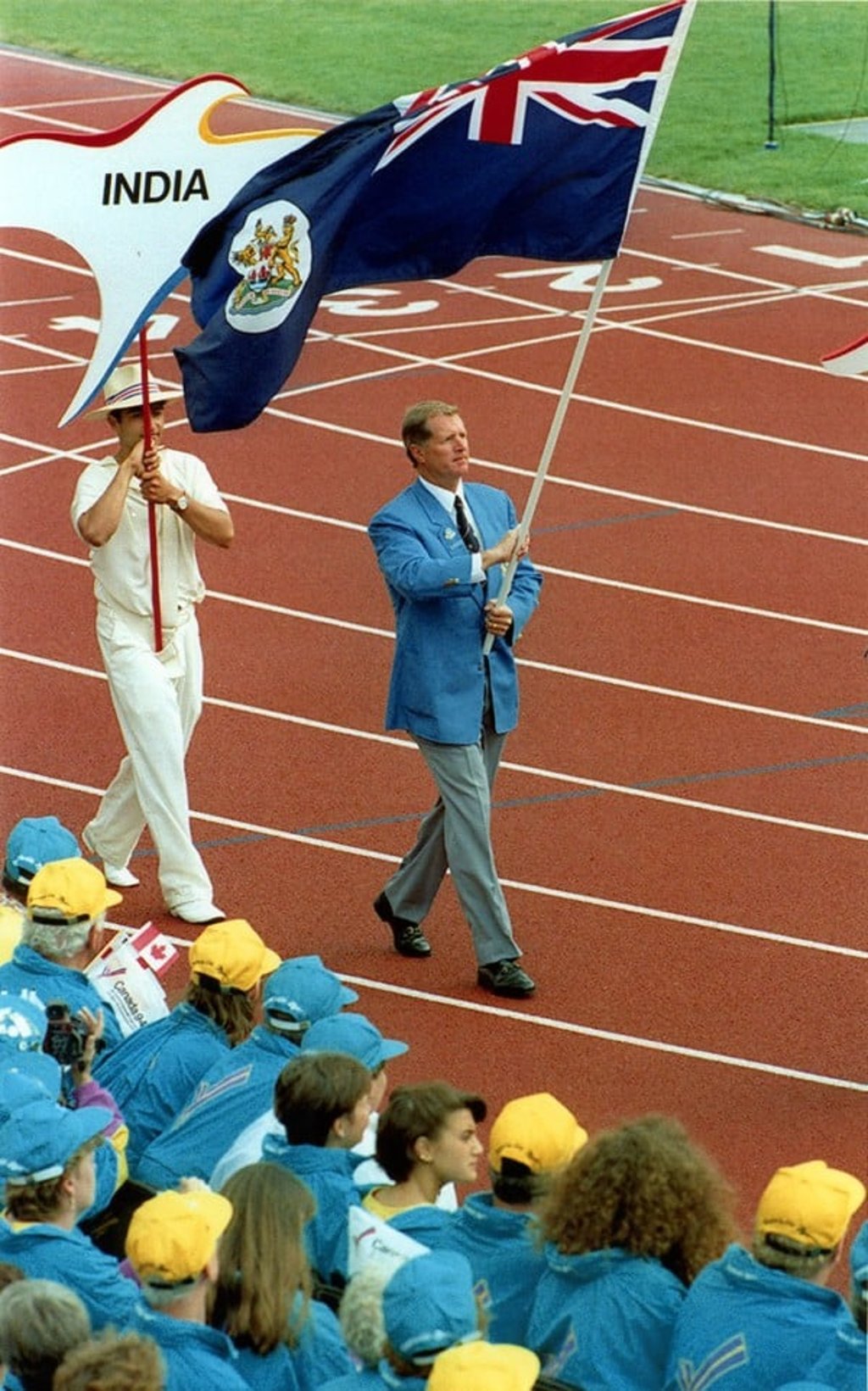 Hong Kong's Ken Wallis carries the flag during the closing ceremony of the 1994 Commonwealth Games. Photo: SCMP/Robert Ng