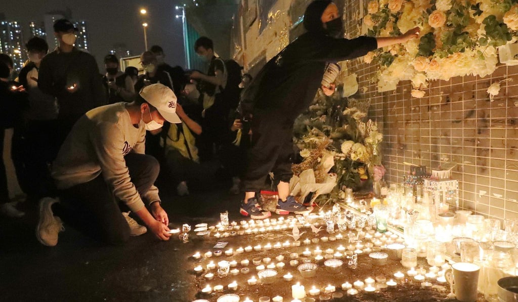 Protesters gather at the car park in Sheung Tak Estate on Sunday to pay tribute to Chow Tsz-lok. Photo: Edmond So
