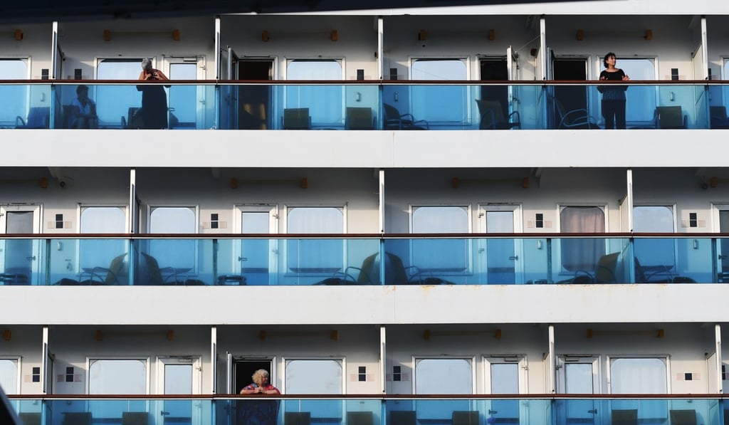 Passengers aboard the Costa Fortuna look on as it docks in Singapore. Photo: Xinhua Passengers aboard the Costa Fortuna look on as it docks in Singapore. Photo: Xinhua