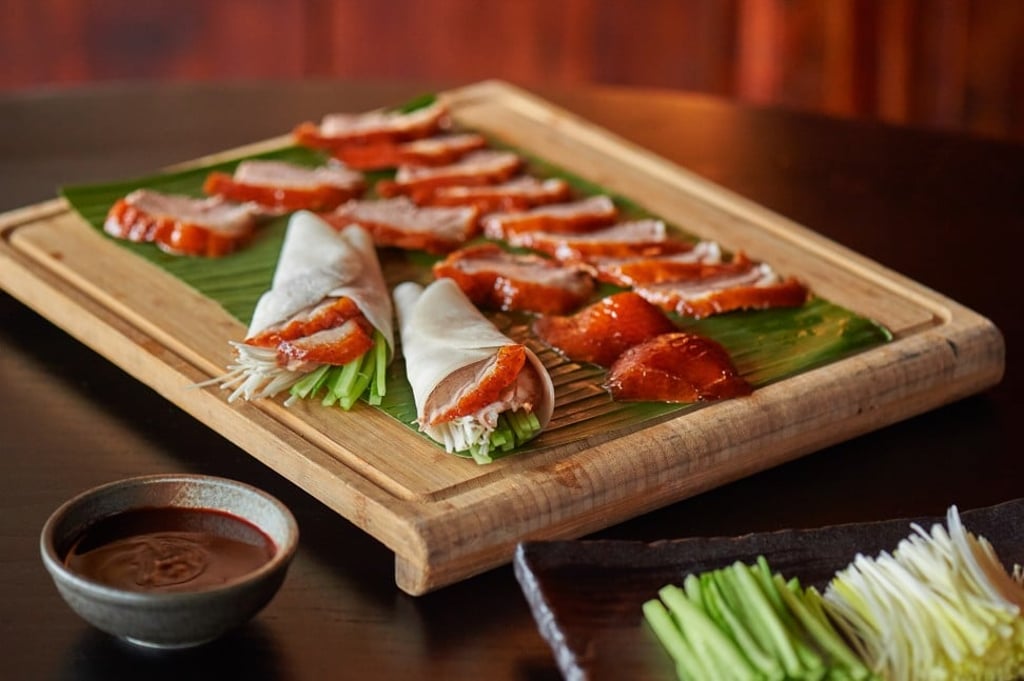 Roasted duck served with sliced spring onions and cucumber.