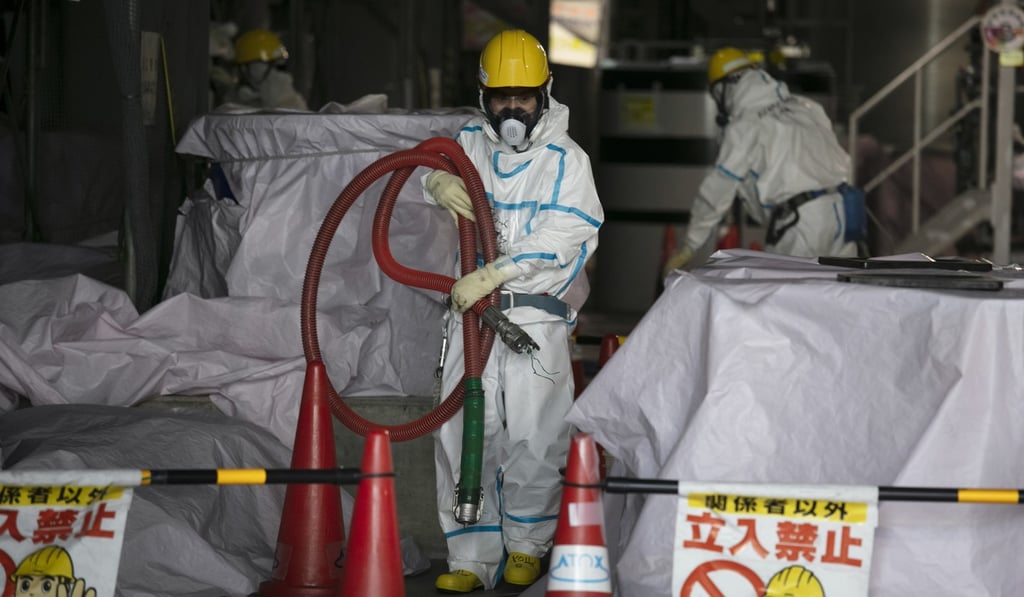 Workers in hazmat suits pictured at a water treatment facility at the Fukushima Daiichi nuclear power plant last month. Photo: AP