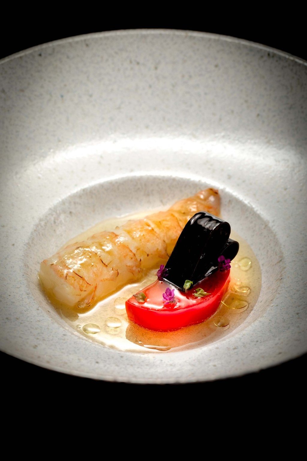 Langoustine served with sweet Japanese tomato in tomato water.