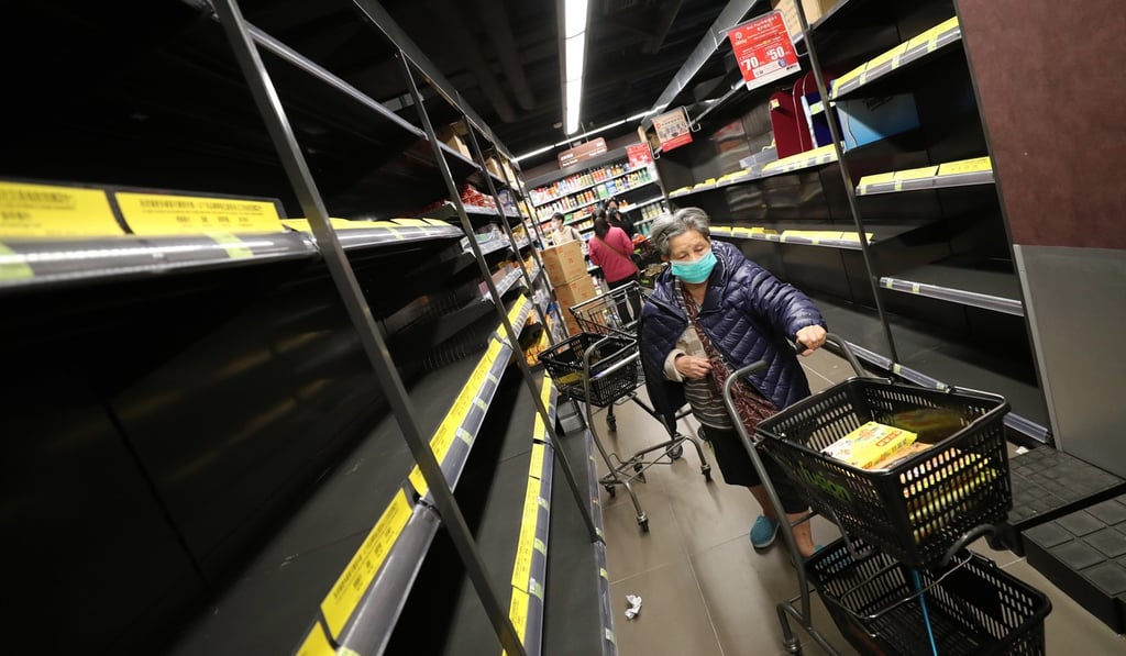 Shoppers pass empty shelves at a supermarket in Hong Kong. Photo: Edward Wong