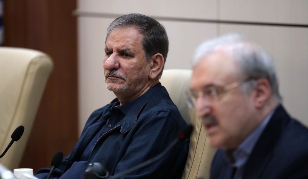 Senior Iranian Vice-President Eshaq Jahangiri (left) listens as Minister of Health and Medical Education Saeed Namaki speaks at the Headquarters of Prevention and Combating the Coronavirus, in Tehran in February. Photo: Office of the Iranian Vice President via AP