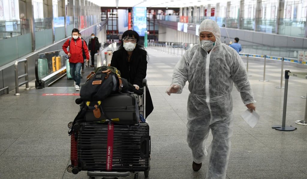 A man wears a protective suit as a preventive measure against the coronavirus as he accompanies a passenger leaving Beijing Capital International Airport this week. People in China have begun to travel again, but the travel industry is far from a return to normal. Photo: AFP