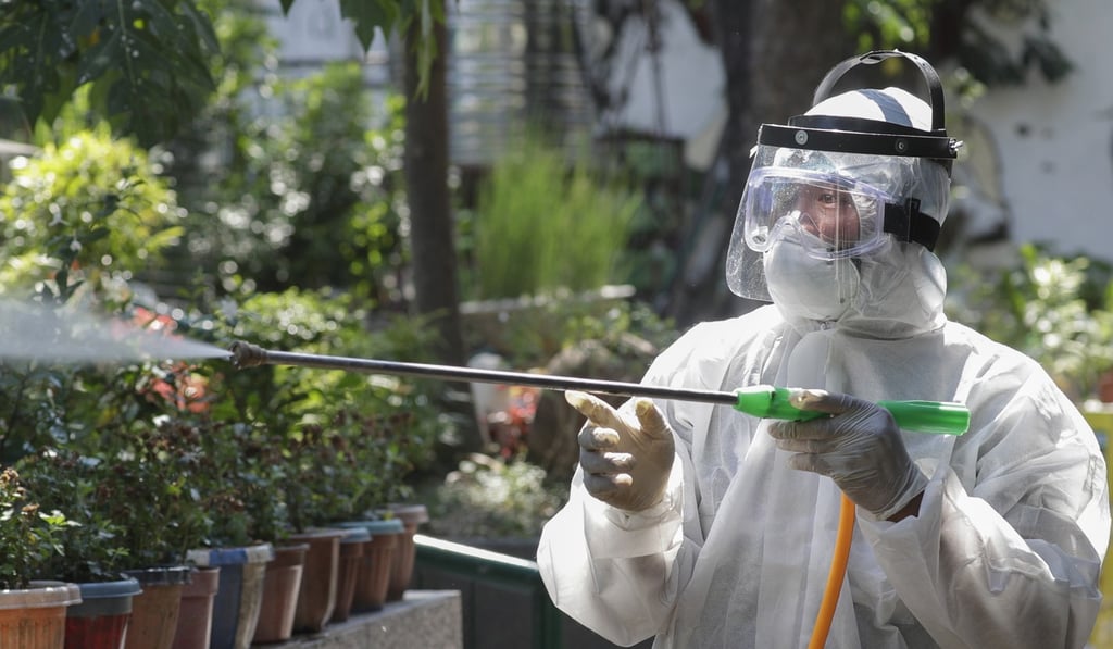 A worker sprays disinfectants at a school in San Juan city that has suspended classes as a precautionary measure against the new coronavirus. Photo: AP