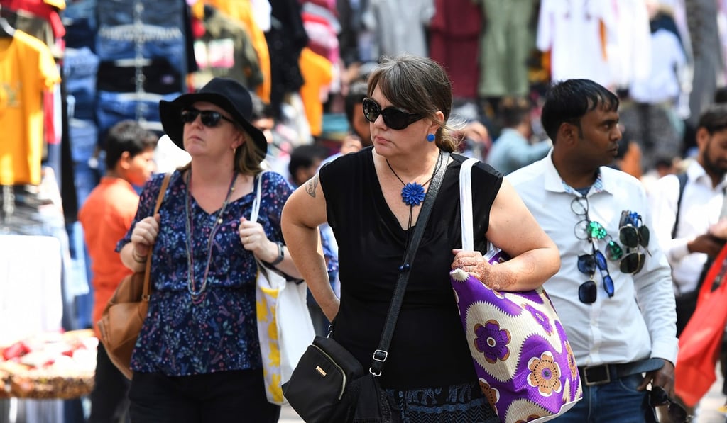Tourists walk along a street in New Delhi on March 12, 2020. Photo: AFP