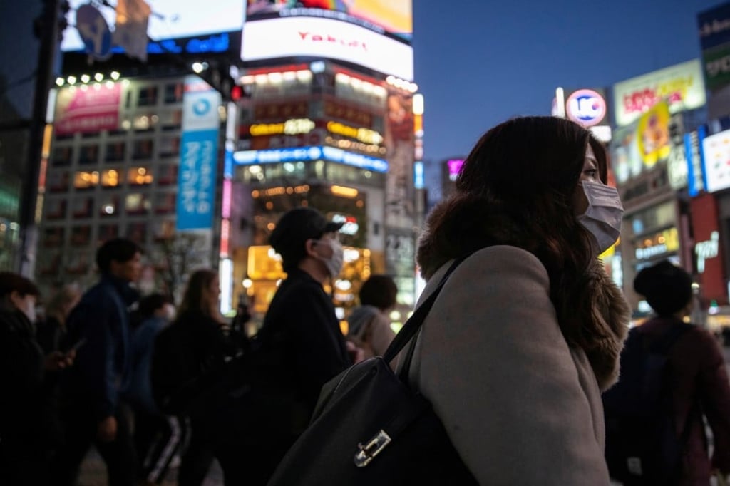 People wear face masks in Tokyo’s Shibuya shopping district following the outbreak of the coronavirus. Photo: Reuters
