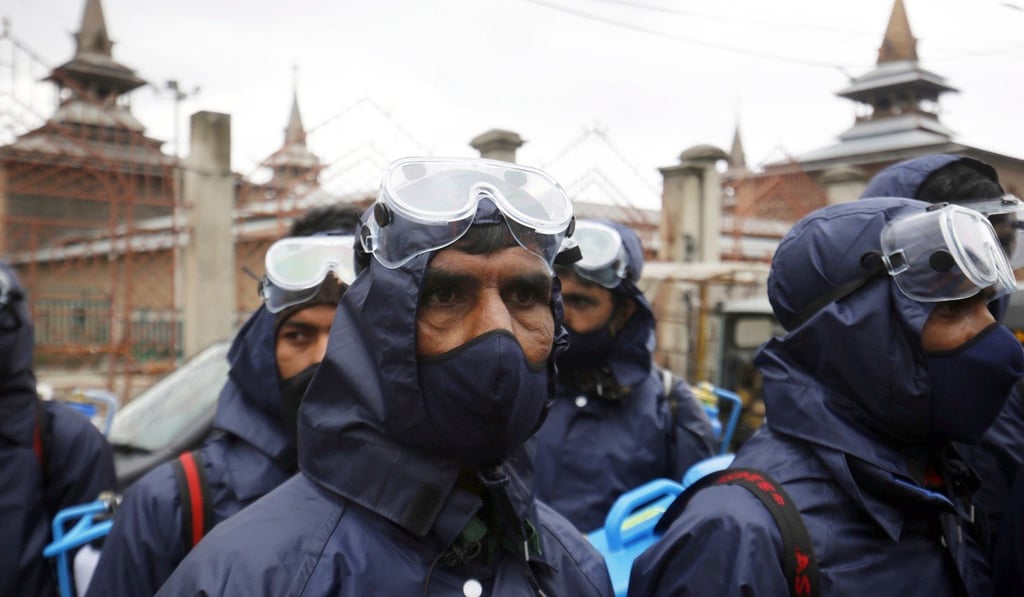 A disinfection team in Srinagar, India. Photo: EPA A disinfection team in Srinagar, India. Photo: EPA