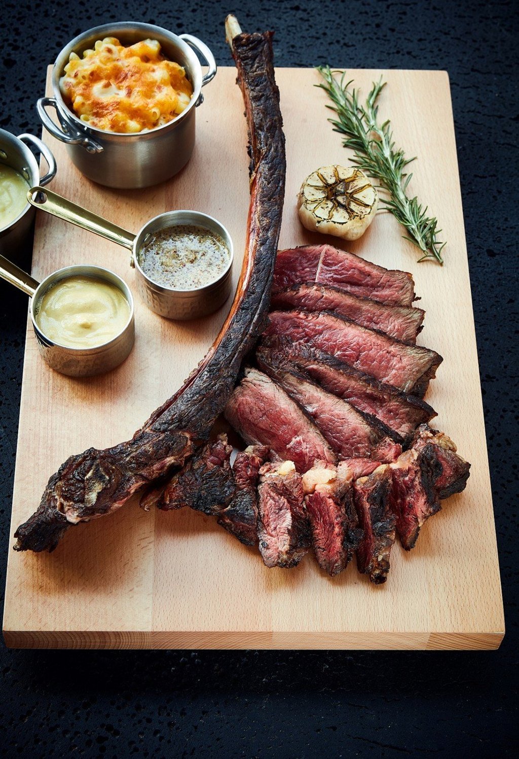 Dry-aged USDA prime bone-in rib eye is marinated with bourbon and oolong tea for 28 days.