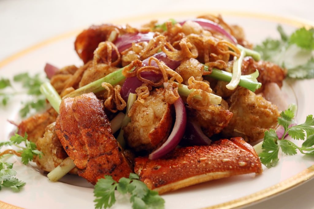 Stir-fried fresh lobster with spring onions, red onions and shallots.