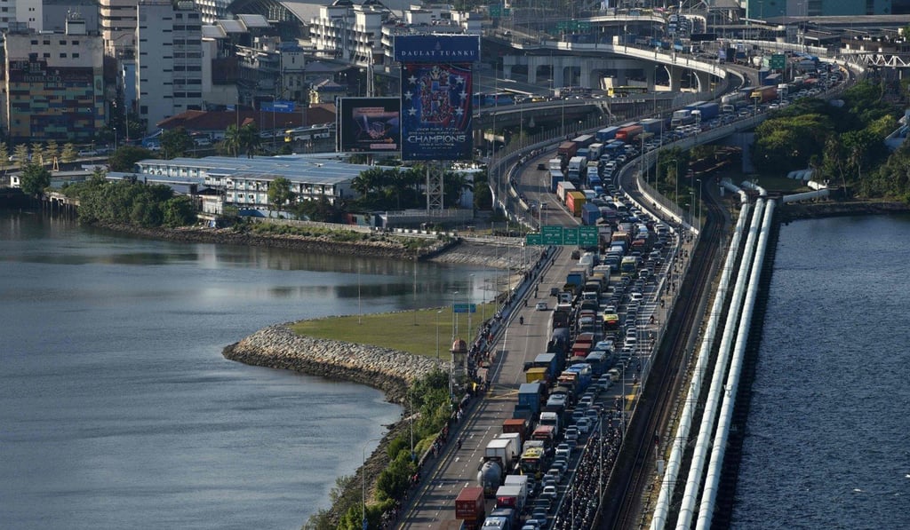 Vehicles queue to enter the Woodlands checkpoint in Singapore after Malaysia announced drastic measures to curb the spread of the coronavirus. Photo: AFP