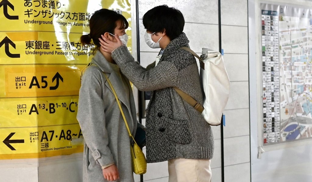 A couple wearing face masks amid concerns about the coronavirus pandemic pictured at a railway station in Tokyo on Sunday. Photo: AFP A couple wearing face masks amid concerns about the coronavirus pandemic pictured at a railway station in Tokyo on Sunday. Photo: AFP