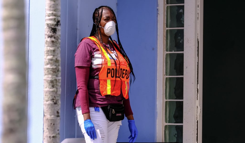 A poll deputy wears gloves and a mask during the Democratic presidential primary election in Miami, Florida, on Tuesday. Photo: Reuters