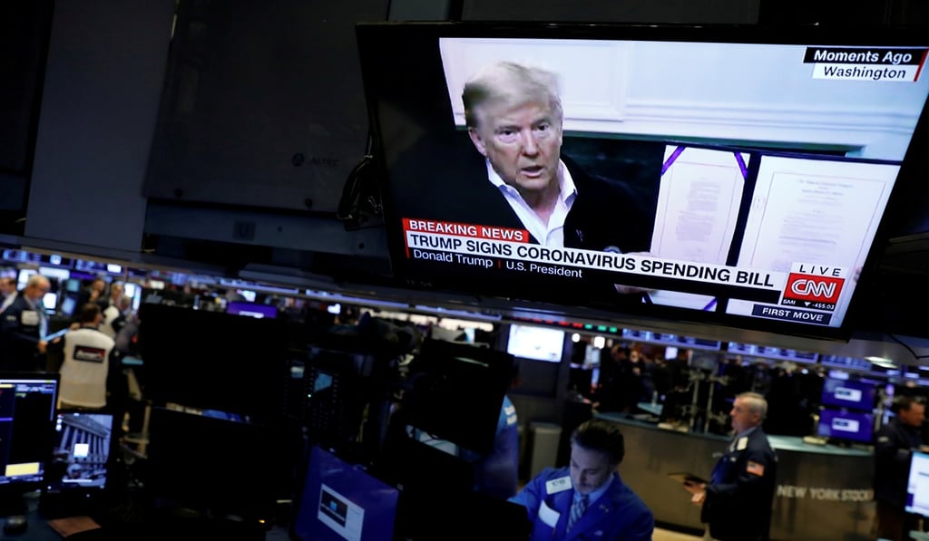 US President Donald Trump is seen on a news broadcast, discussing the coronavirus spending bill, on the trading floor at the New York Stock Exchange on March 6. Photo: Reuters