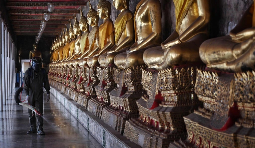 Disinfection work at Wat Suthat Thepwararam temple in Bangkok. Photo: AFP Disinfection work at Wat Suthat Thepwararam temple in Bangkok. Photo: AFP