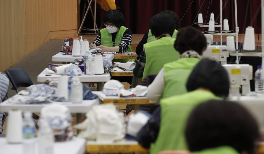 Volunteers make protective masks to donate to their neighbours in Seoul, South Korea. Photo: AP