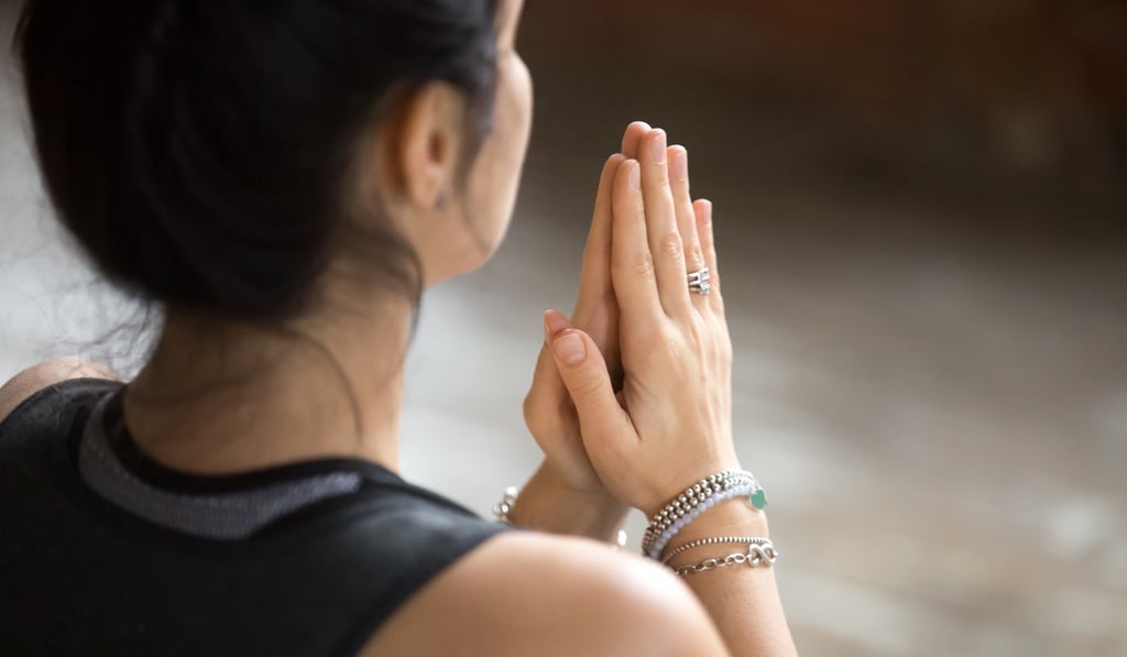The normal hugging and physical contact have been replace by a namaste in a church on LA’s Westside. Photo: Shutterstock