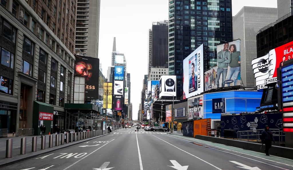 A nearly deserted Times Square, New York, last Thursday. The city has shut down entertainment to contain the spread of coronavirus. Reuters