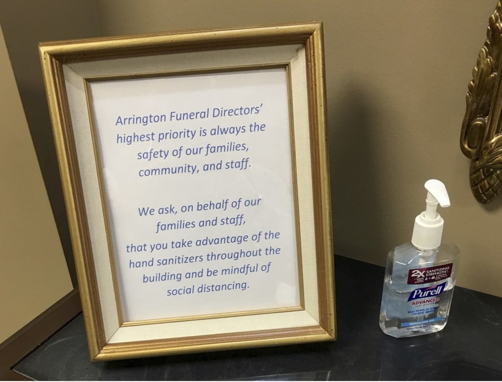 Arrington Funeral Directors show a sign requesting visitors to use hand sanitiser and maintain social distancing amid the coronavirus outbreak, at their funeral home in Jackson, Tennessee. Photo: AP Arrington Funeral Directors show a sign requesting visitors to use hand sanitiser and maintain social distancing amid the coronavirus outbreak, at their funeral home in Jackson, Tennessee. Photo: AP