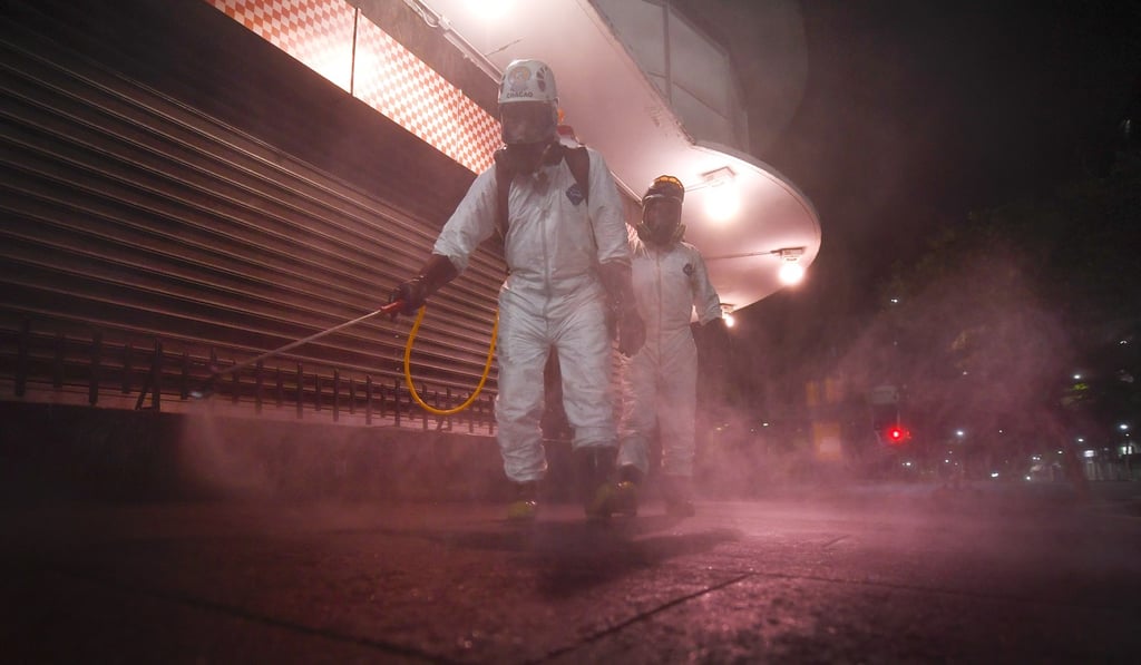 City workers spray disinfectant to prevent the spread of coronavirus in Caracas, Venezuela, on Sunday. Photo: AP Photo