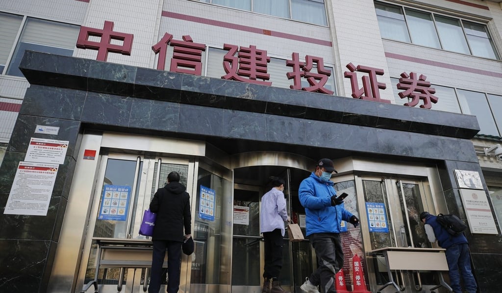 People pass by a stock brokerage in Beijing. Chinese stocks have fared far better than most global equities amid the coronavirus outbreak. Photo: AP Photo
