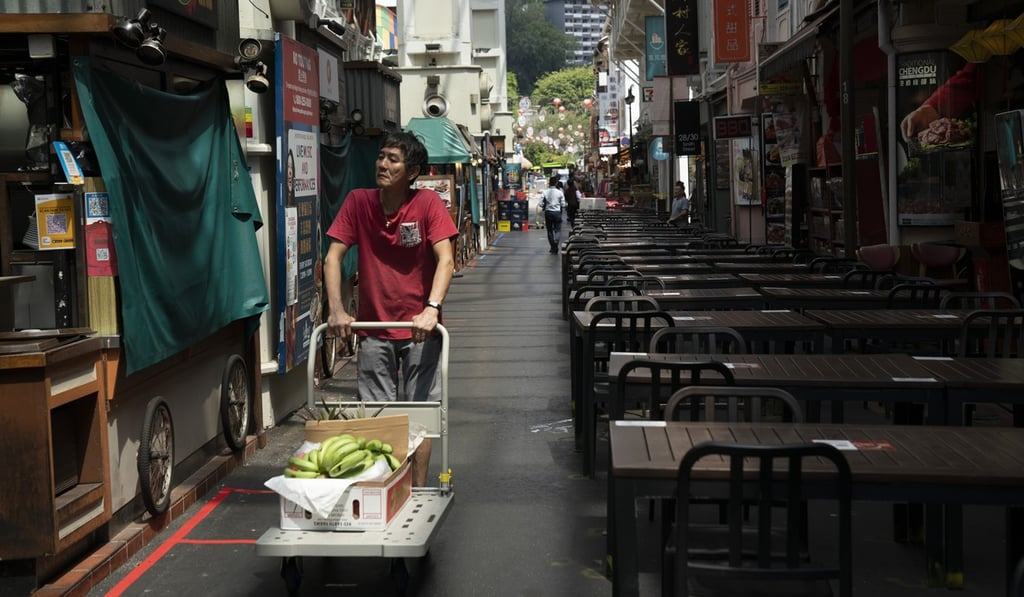 A man delivers food at the nearly empty Chinatown Food Street in Singapore on March 24. Photo: Bloomberg