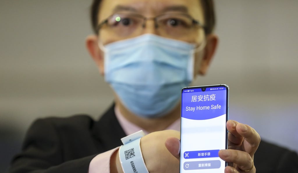 Victor Lam shows the ‘Stay Home Safe’ app which is connected to the tracking wristband. Photo: Winson Wong