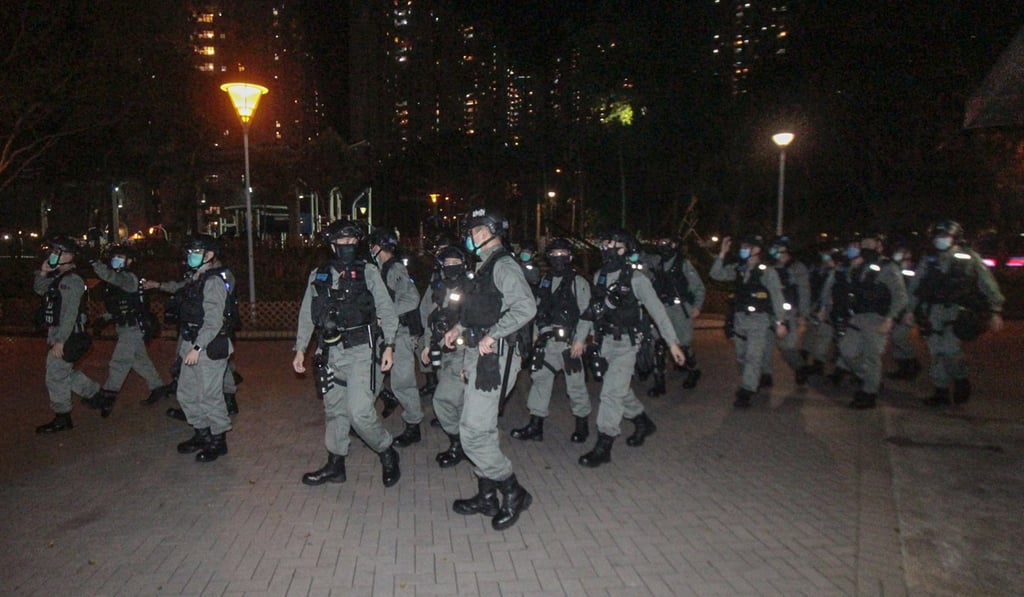Officers in riot gear arrive to escort the suspects to police vehicles. Photo: Handout