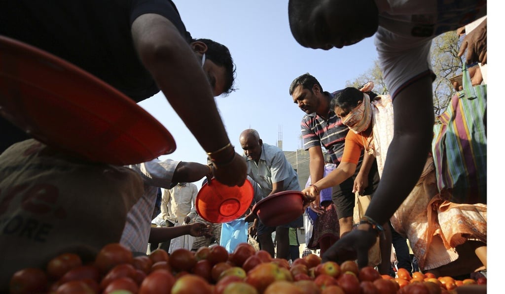 People buy vegetables during lockdown in Bangalore, India. Photo: AP