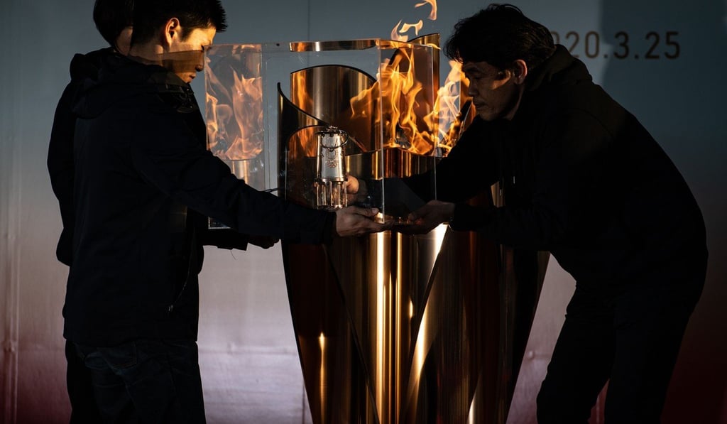 The Olympic flame is transferred to a lantern at the Aquamarine Fukushima aquarium in Iwaki, Fukushima prefecture, the day after the historic decision to postpone the 2020 Tokyo Games. Photo: AFP