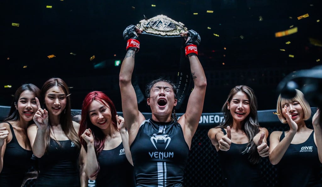 Angela Lee raises her atomweight belt. Photo: One Championship